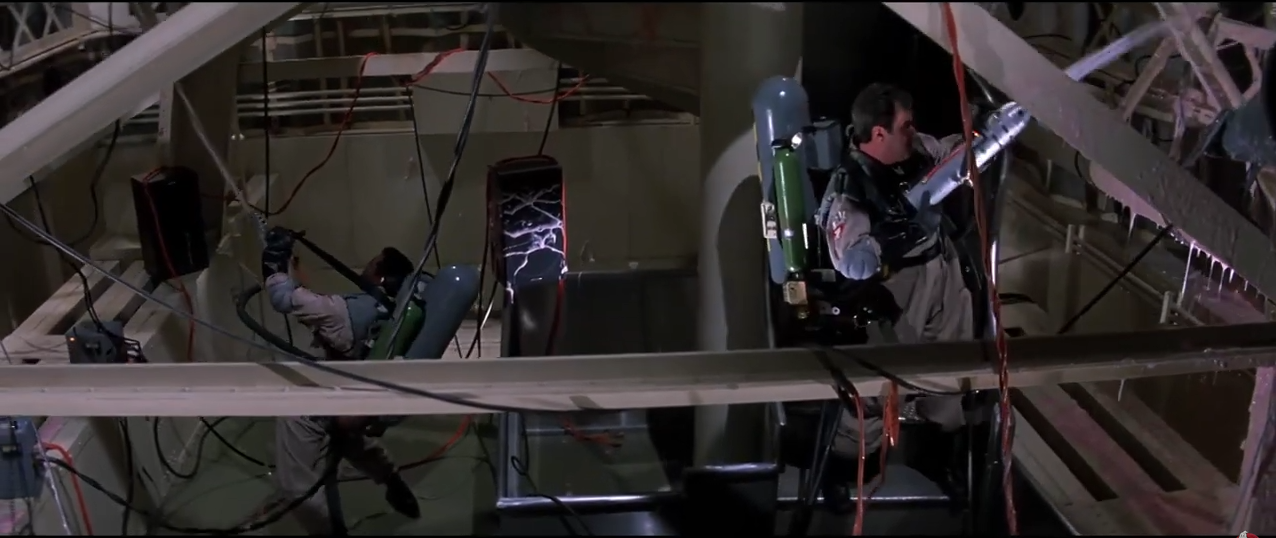 Two ghostbusters coating the insides of the Statue of Liberty with slime from big phallic shaped guns.